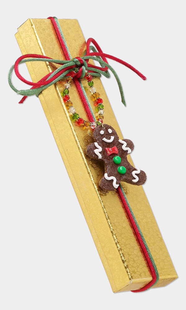 image of a package that is embellished with a polymer clay gingerbread man